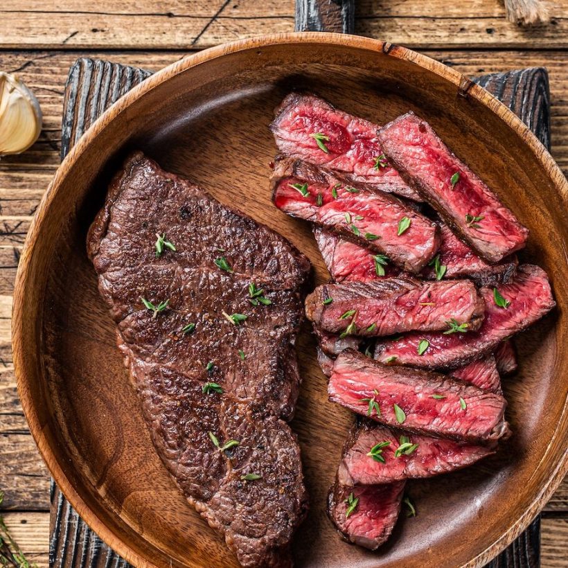 grilled-sliced-top-blade-or-denver-beef-meat-steak-in-a-wooden-plate-with-herbs-.jpg